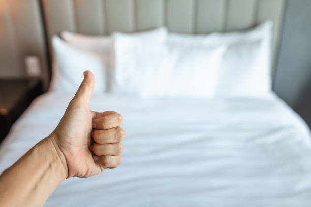 Thumbs up for hotel clean bed white sheets. housekeeper.